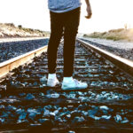 Discernment - A person standing on train tracks