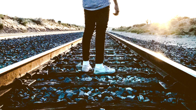 Discernment - A person standing on train tracks