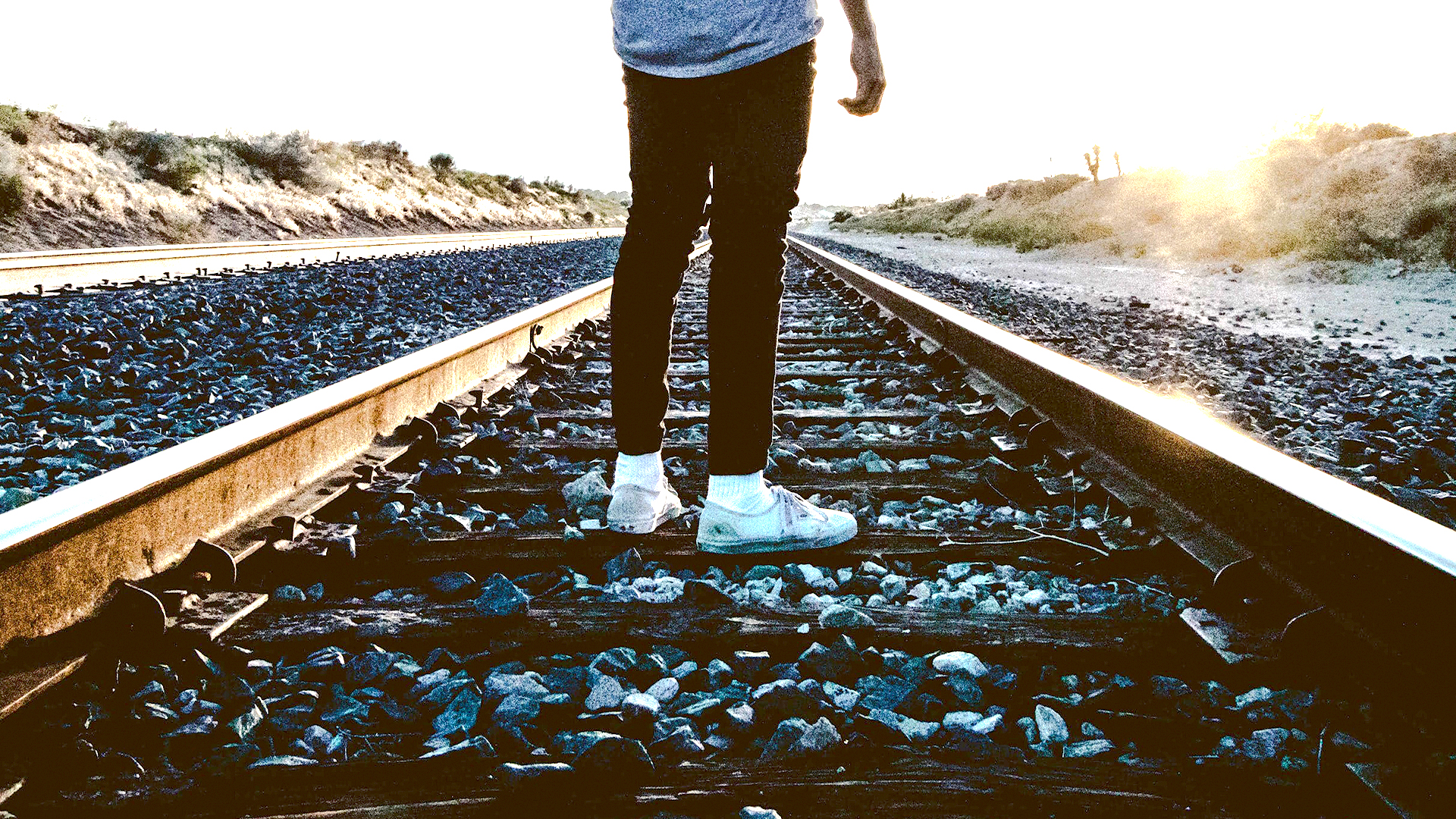 Discernment - A person standing on train tracks