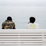 Counselling - Two guys sitting on a bench, looking out at the ocean