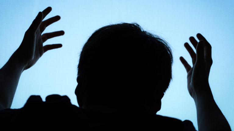 Repentance - A guy holding his hands up to the sky praying