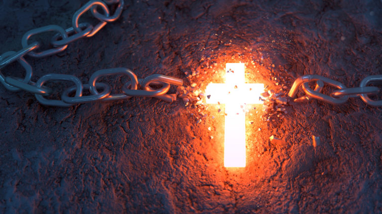Christ Jesus and sin - An image of a glowing cross with chains broken chains on either side