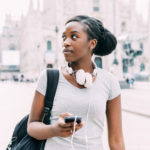 Hope - A woman walking in the road of a foreign country