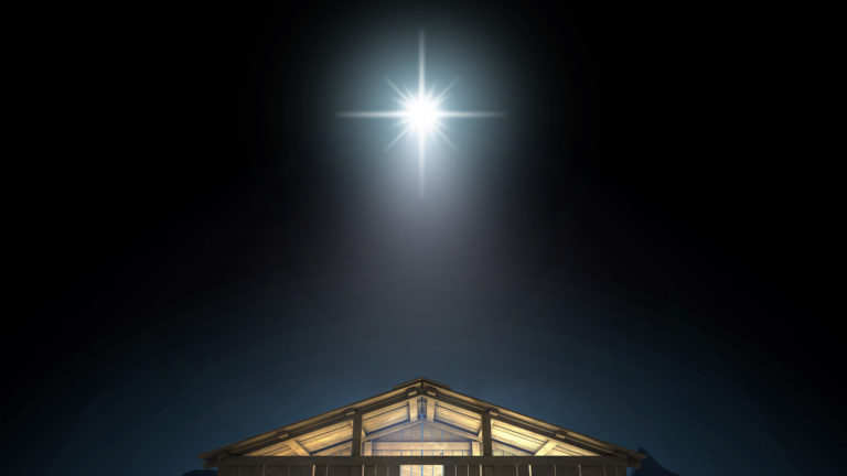 Christmas and God with us - A star in the dark sky above the manger