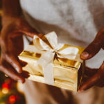 God's presence - A person holding a Christmas present in their hands