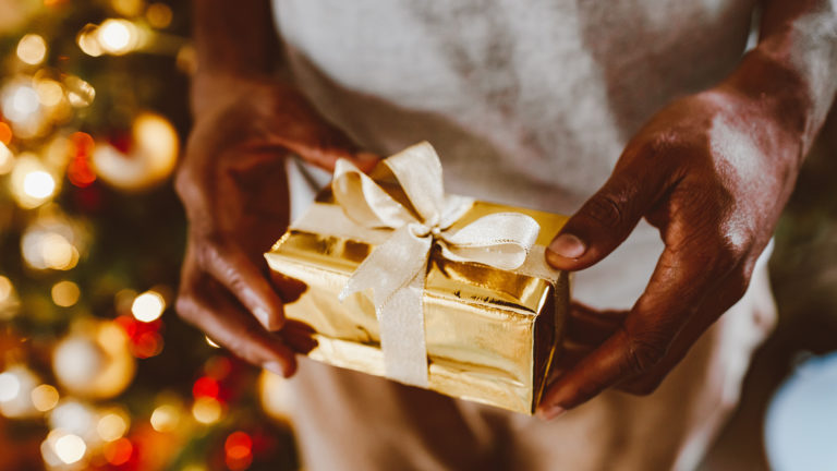 God's presence - A person holding a Christmas present in their hands