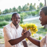 Friendships - Two me smiling and greeting each other with a handshake