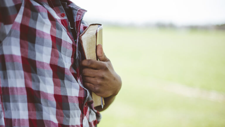 Applying The Old Testament – A picture of a guy holding a bible to his chest