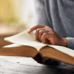 Bible reading - A person reading and paging through the bible