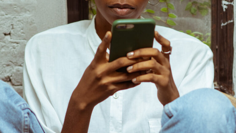 Harsh speech on social media - A woman on her phone