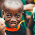 On children - A boy smiling with other kids around him