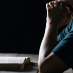 Covenant theology - A person sitting in front of their open bible thinking