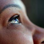 Weakness and God's Strength – A woman's face and her eyes are looking up to the sky