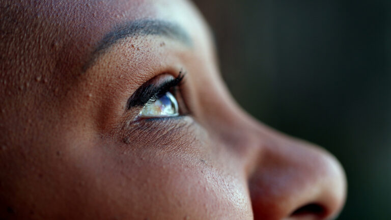 Weakness and God's Strength – A woman's face and her eyes are looking up to the sky