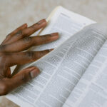 Lament and Scripture – A woman paging through the bible