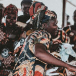 Dance in Worship – A woman dancing amongst other women