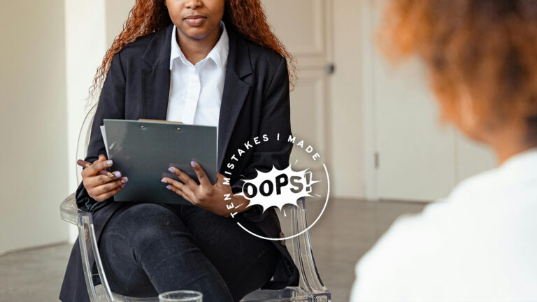 Biblical Counselor – A woman sitting on a chair with a book and pen, sitting opposite another woman.