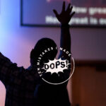 Being a new christian – A person in church, raising their hands above their head
