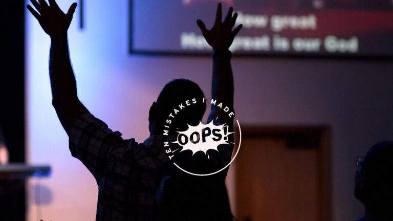 Being a new christian – A person in church, raising their hands above their head