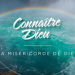 Mercy of God: A picture of a rainbow over the ocean in the background.